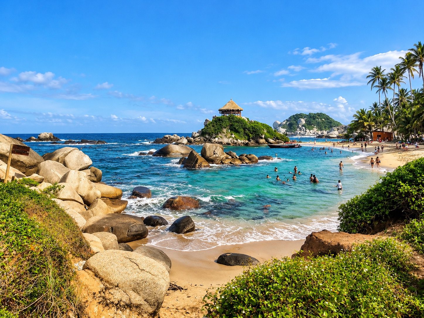 Caribbean beach with turquoise water, granite rocks and palm trees in Tayrona National Natural Park